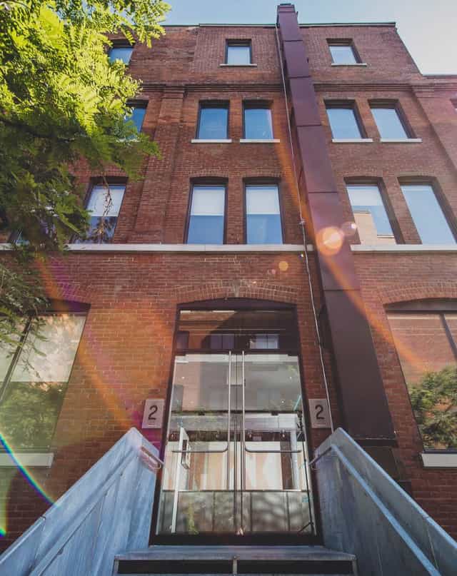 Charming brick event venue in Toronto with large windows for networking and gatherings.
