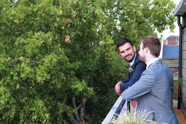 Professionals networking on a balcony at Wallacespace Clerkenwell Green, surrounded by greenery.