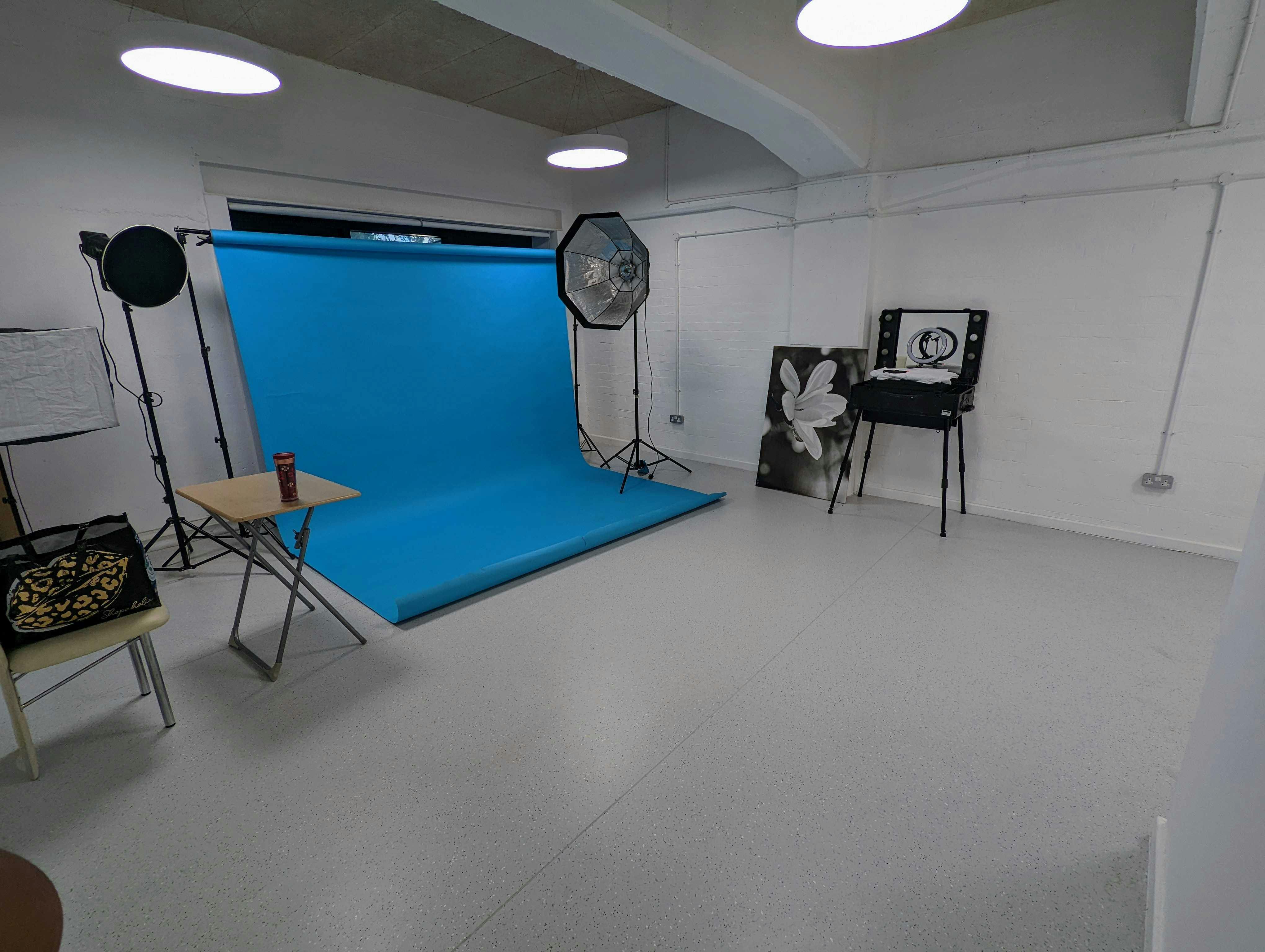 Vision Wharf Studios event space with bright blue backdrop for photography and gatherings.