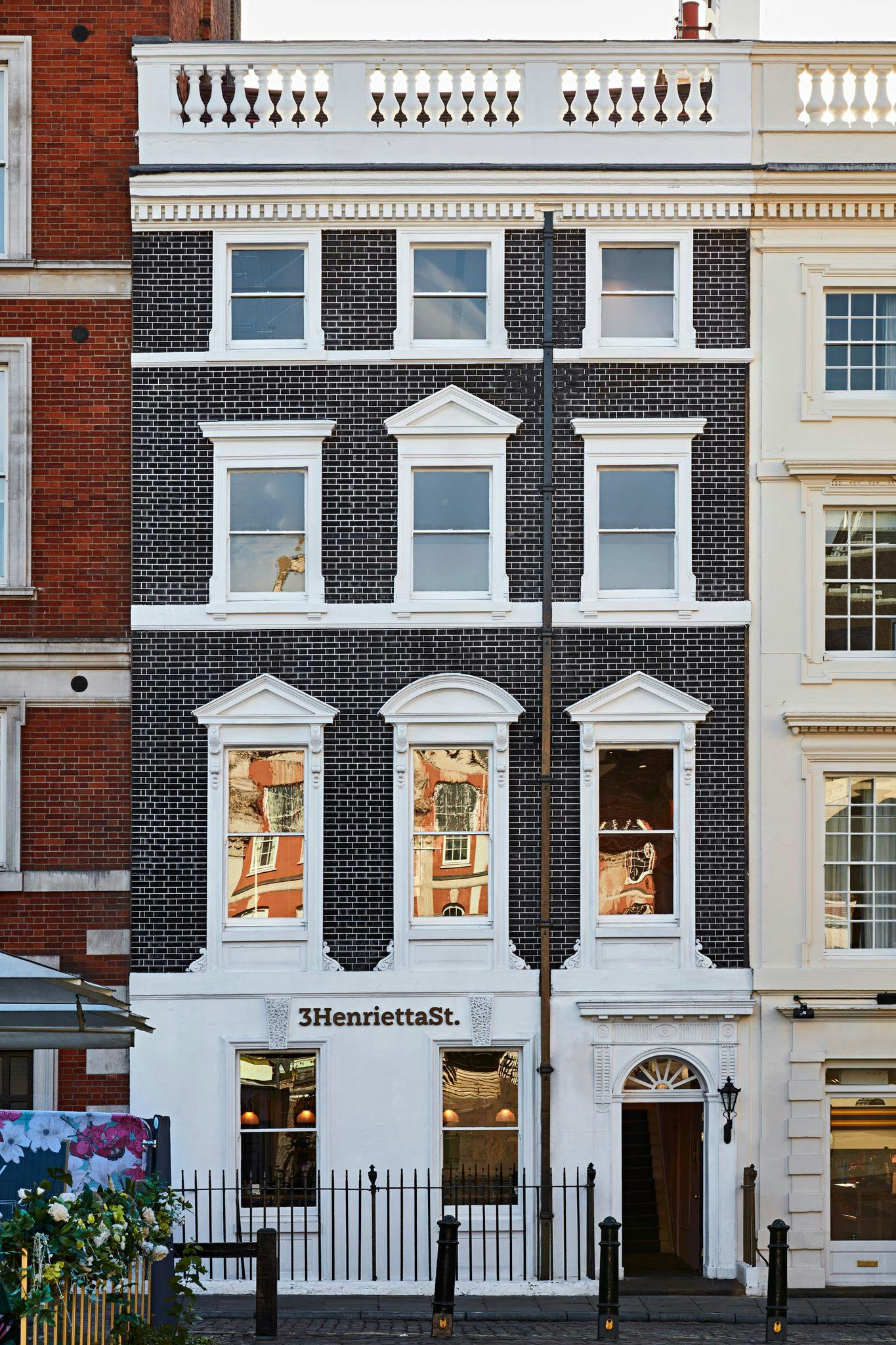 Charming building facade with windows, ideal for unique urban events and gatherings.