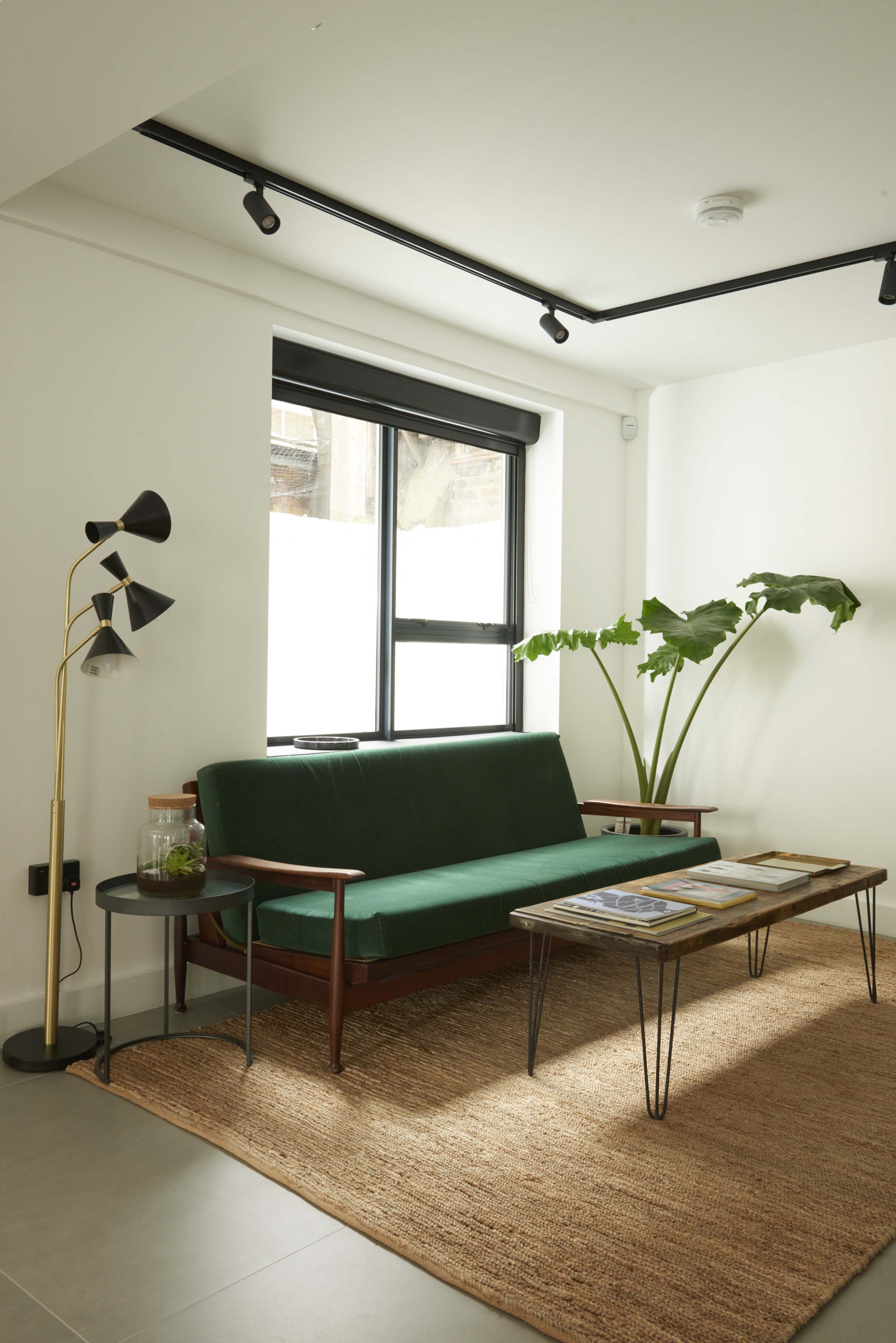 Stylish lounge at Agdon House with green sofa, ideal for networking events. - Banner