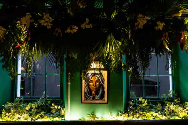 Vibrant event space at El Ta'koy with lush greenery and striking artwork for creative gatherings.