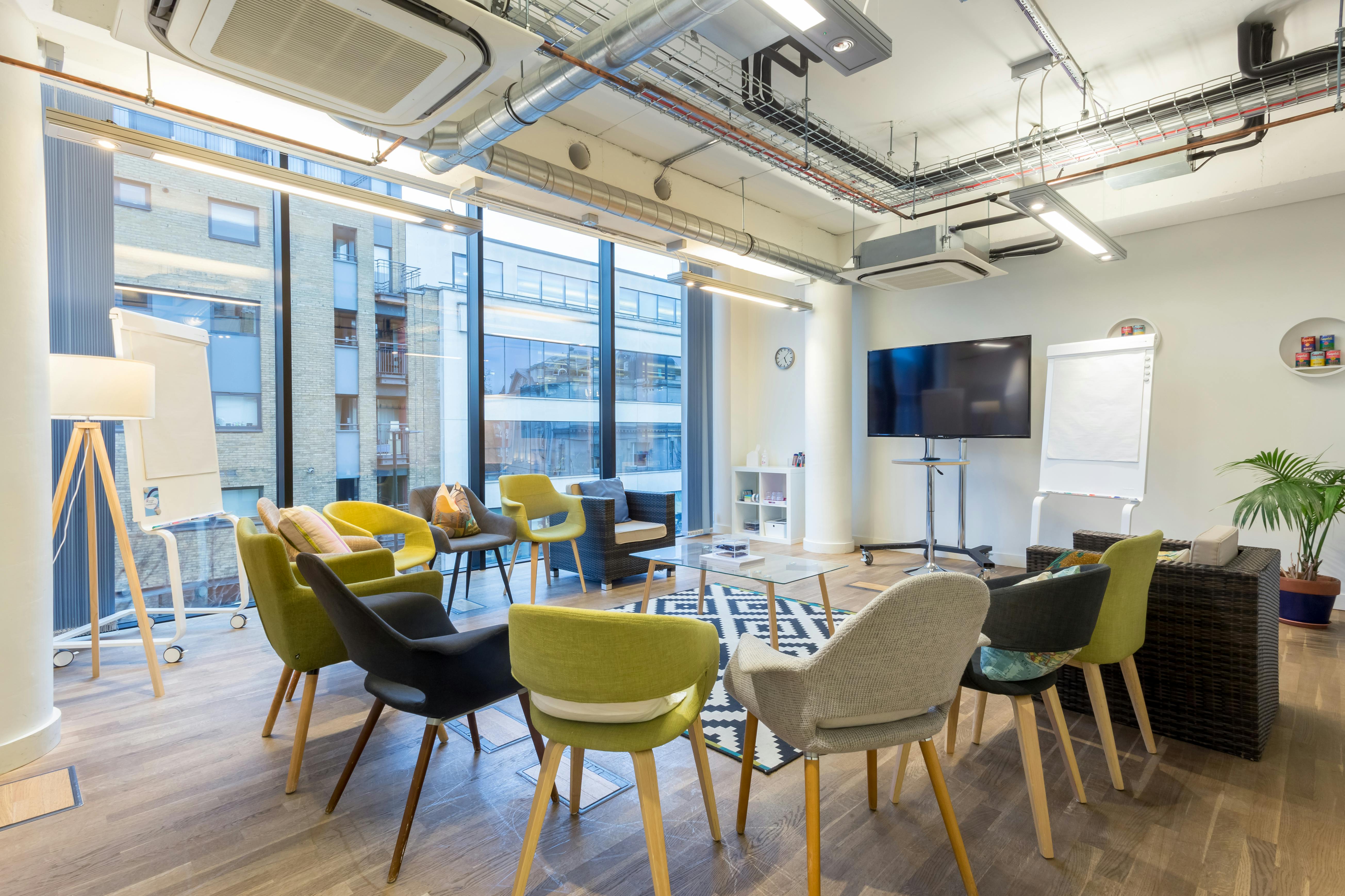 Modern meeting space with colorful chairs for creative workshops at Wallacespace Clerkenwell.