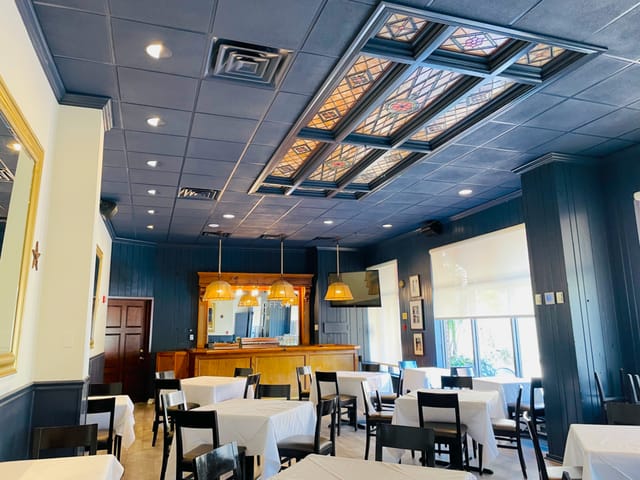 The Riley Room at Chef Geoff's, featuring stained glass, perfect for events and gatherings.