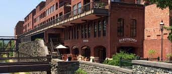 Entire Ballroom at Pinstripes DC, rustic brick venue for corporate events and social gatherings.