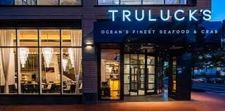 "Truluck's Marina Room entrance, modern venue for upscale corporate dinners and events."