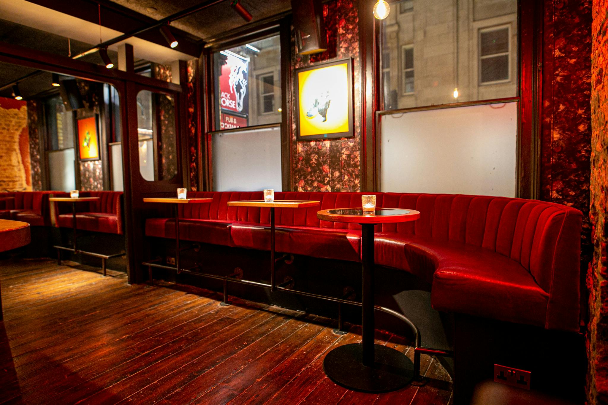 Intimate venue with plush red seating, ideal for networking events in London.