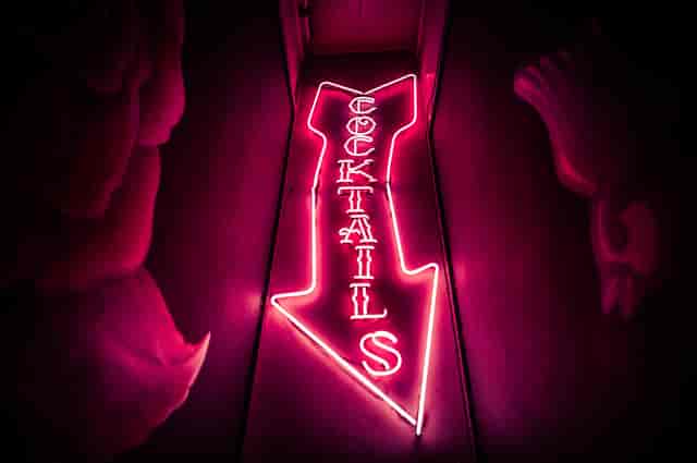 Vibrant neon cocktail sign at The Cocktail Club Cardiff for social events and networking.