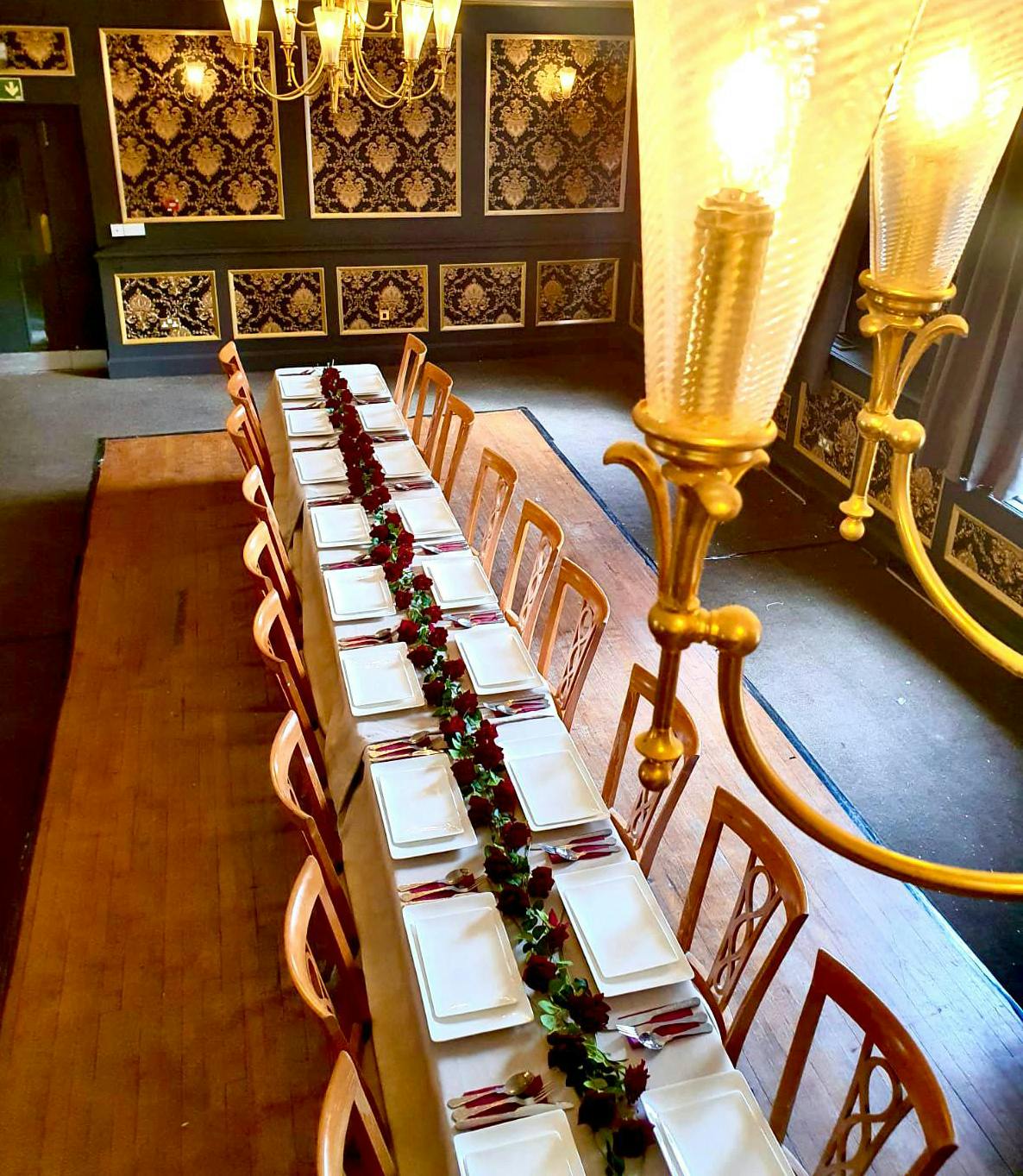 Elegant dining table in Garrison Tavern ballroom for formal events and corporate meetings.