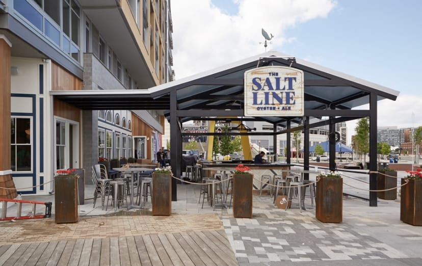 Stylish outdoor bar and patio at The Salt Line, perfect for summer events and gatherings.
