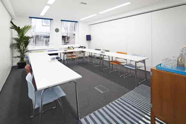 Meeting room with colorful chairs, natural light for collaboration in Covent Garden.
