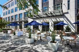 Main Dining Room at La Bise: elegant outdoor venue with blue umbrellas for events.