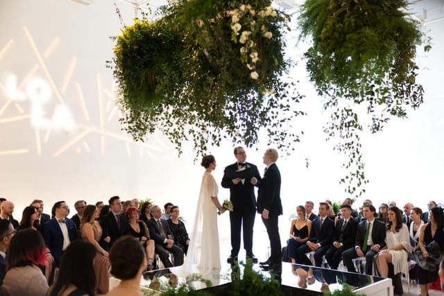 Elegant wedding ceremony at San Francisco Museum of Modern Art with floral installation.