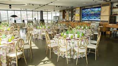 Elegant event space with floral tables and gold chairs for a stylish banquet in San Francisco.