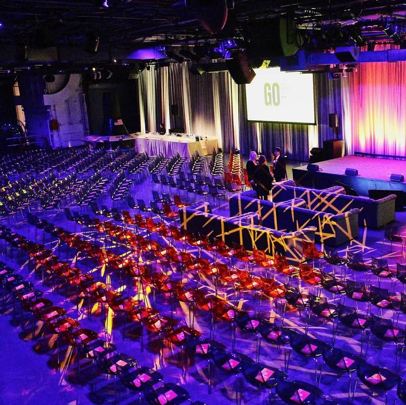 Intrepid Sea, Air & Space Museum event space with theater seating and vibrant lighting.
