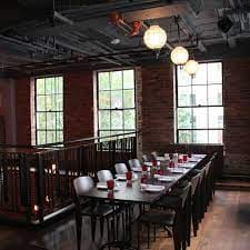 Bulletin Room at Bar Deco: inviting event space with rustic brick walls and natural light.
