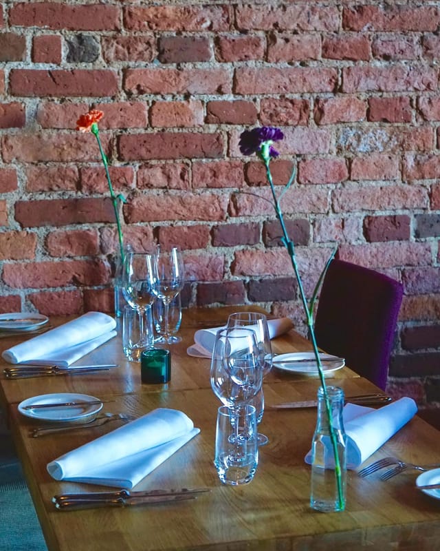 Cozy private dining room with elegant table settings for intimate gatherings or corporate events.