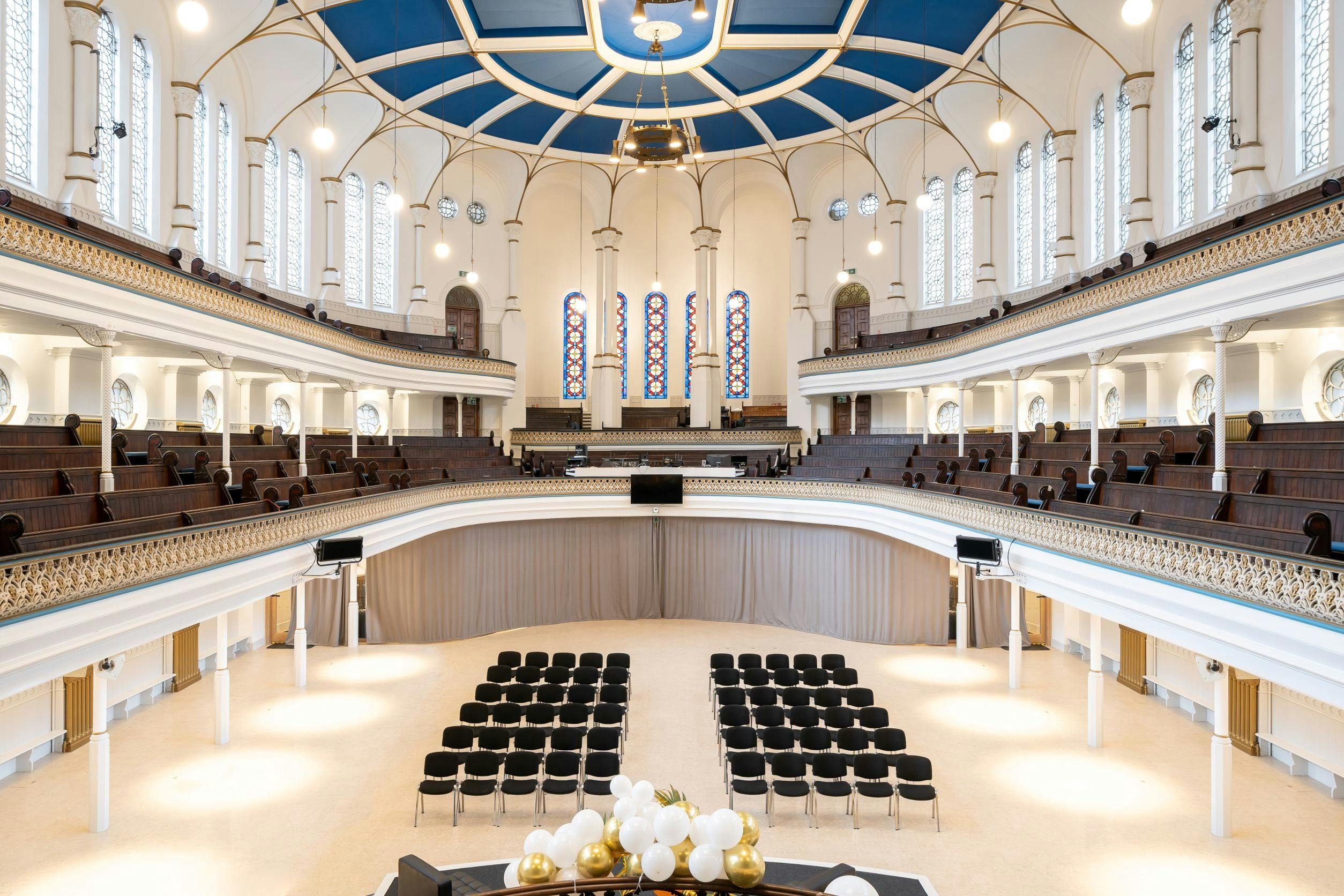 Elegant Westminster Chapel auditorium with high ceilings, ideal for conferences and weddings.