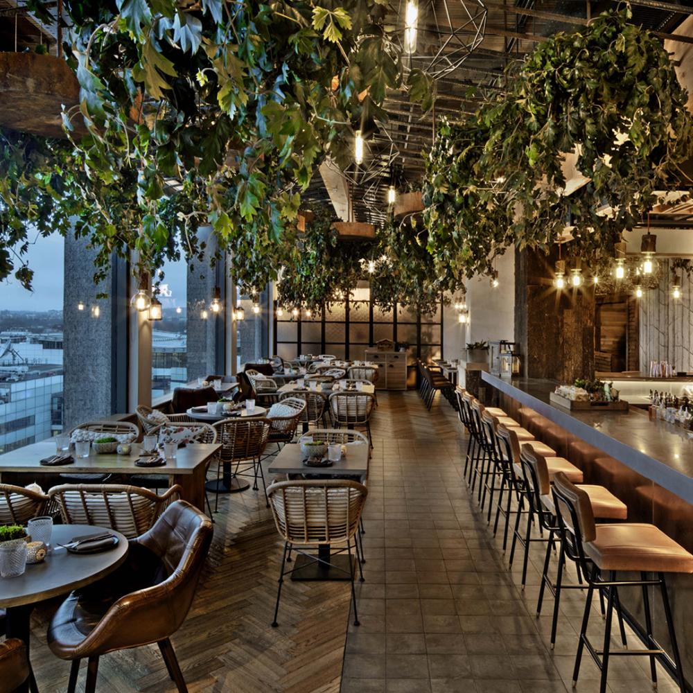 Stylish event space at Treehouse London with lush greenery and warm lighting. - Banner