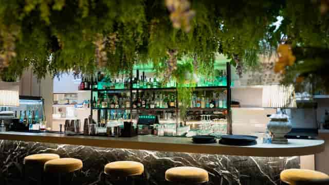 Stylish Garden Rooftop bar with marble counter, ideal for networking events and cocktail receptions.