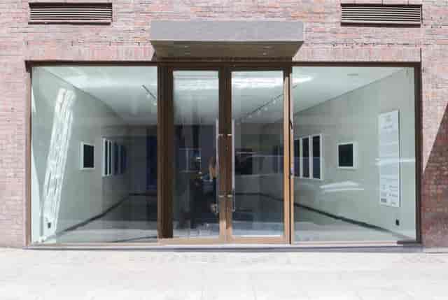 Modern NFT Gallery with glass doors, perfect for art exhibitions and corporate events.