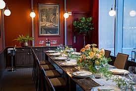 Elegant dining table setup for corporate dinners at DBGB DC, featuring floral centerpiece.