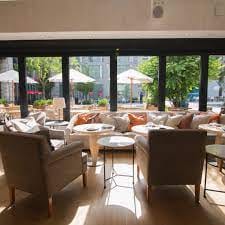 Stylish lounge at Fig & Olive DC with natural light, perfect for networking events.