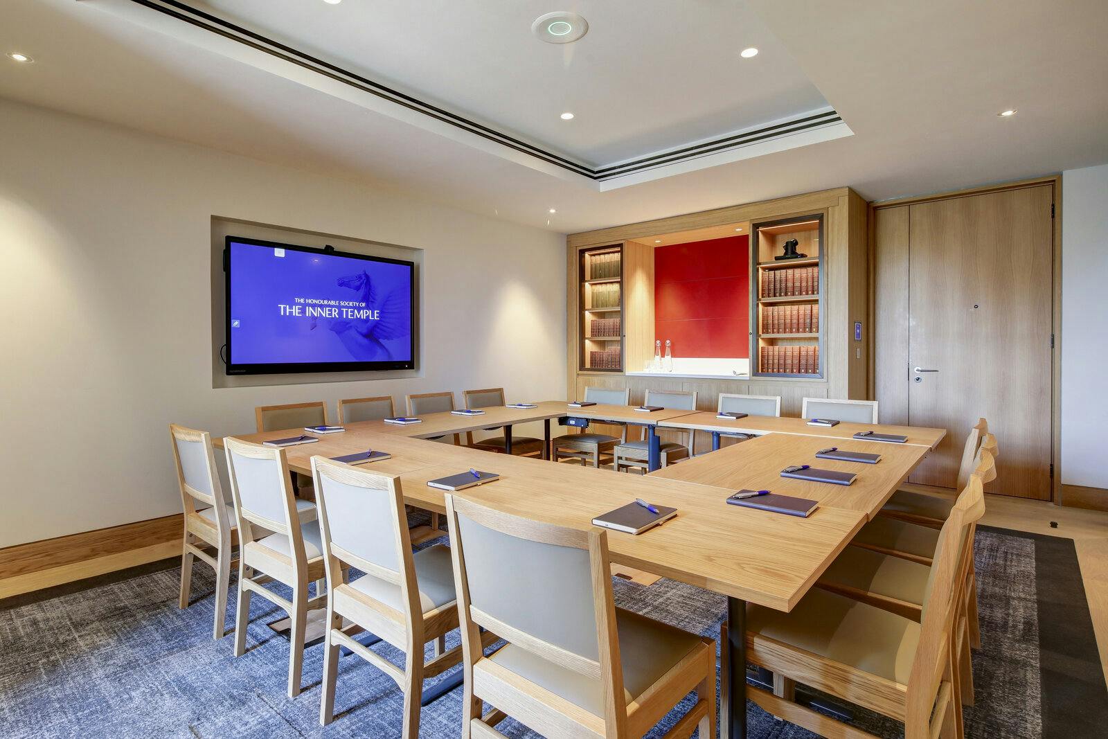 Modern meeting room with wooden table, ideal for collaborative events and presentations.