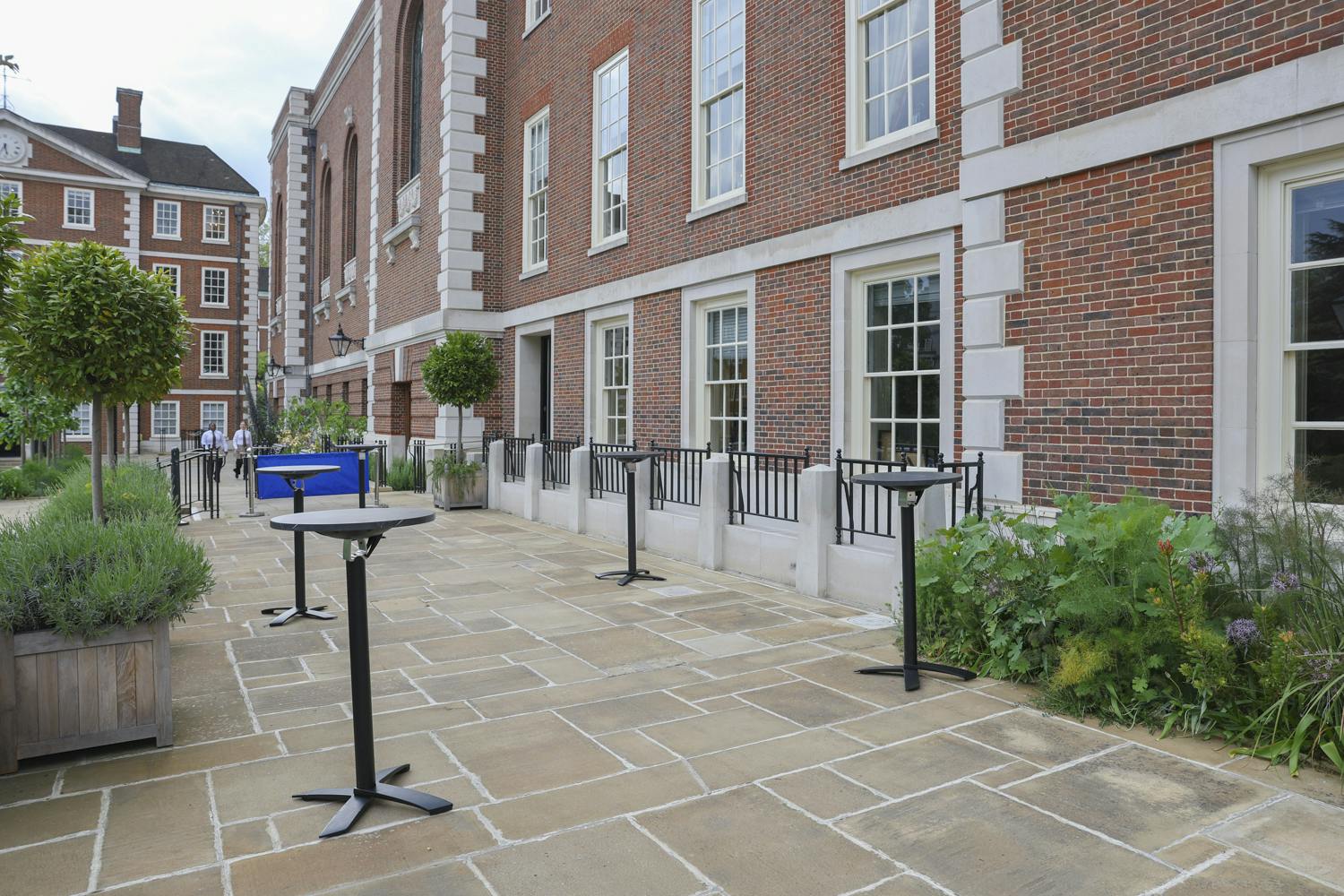 Outdoor event space at The Terrace, featuring stone patio and high-top tables for gatherings.