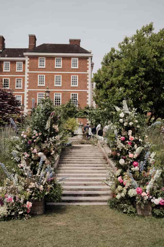 Elegant garden venue with floral arrangements, ideal for weddings and parties.