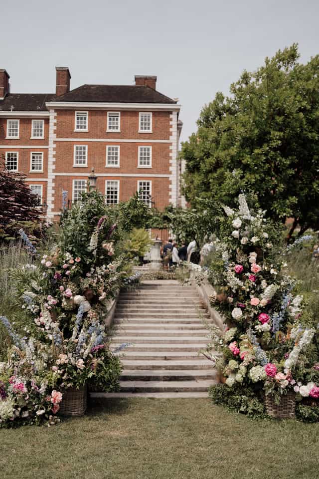 Elegant garden venue with floral arrangements, ideal for weddings and parties.