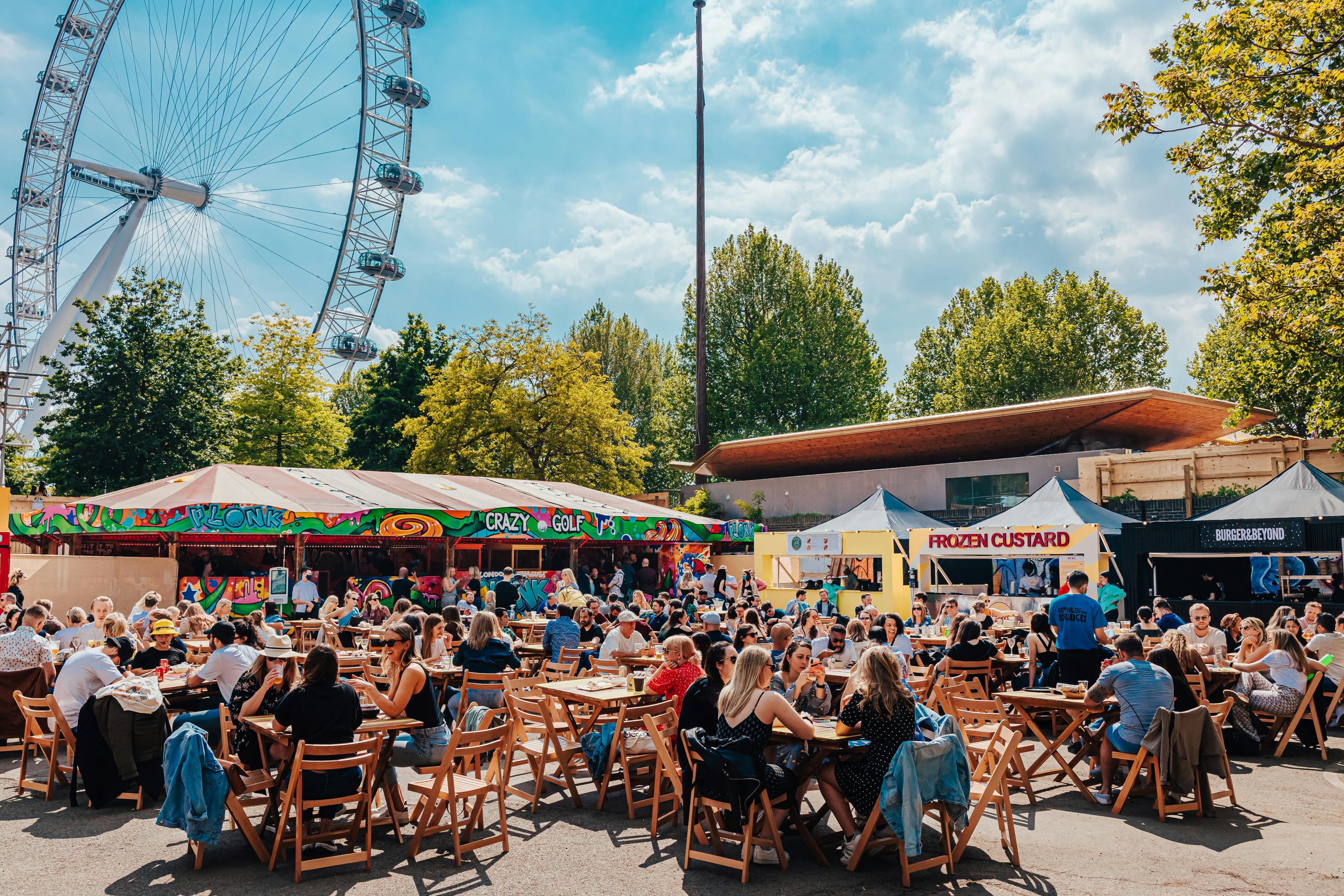 Vibrant outdoor event space with Ferris wheel, ideal for festivals and gatherings.