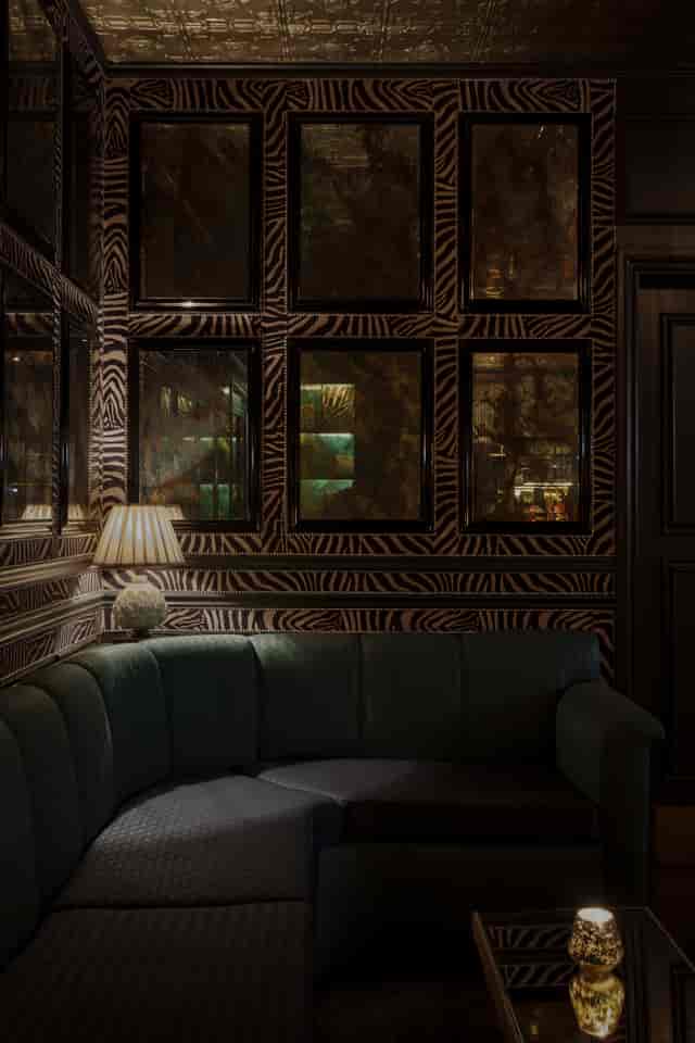 Stylish lounge bar with zebra-striped wallpaper, perfect for networking events.