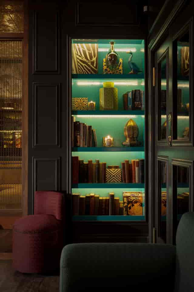 Lounge Bar bookshelf with teal backdrop, perfect for networking events and gatherings.