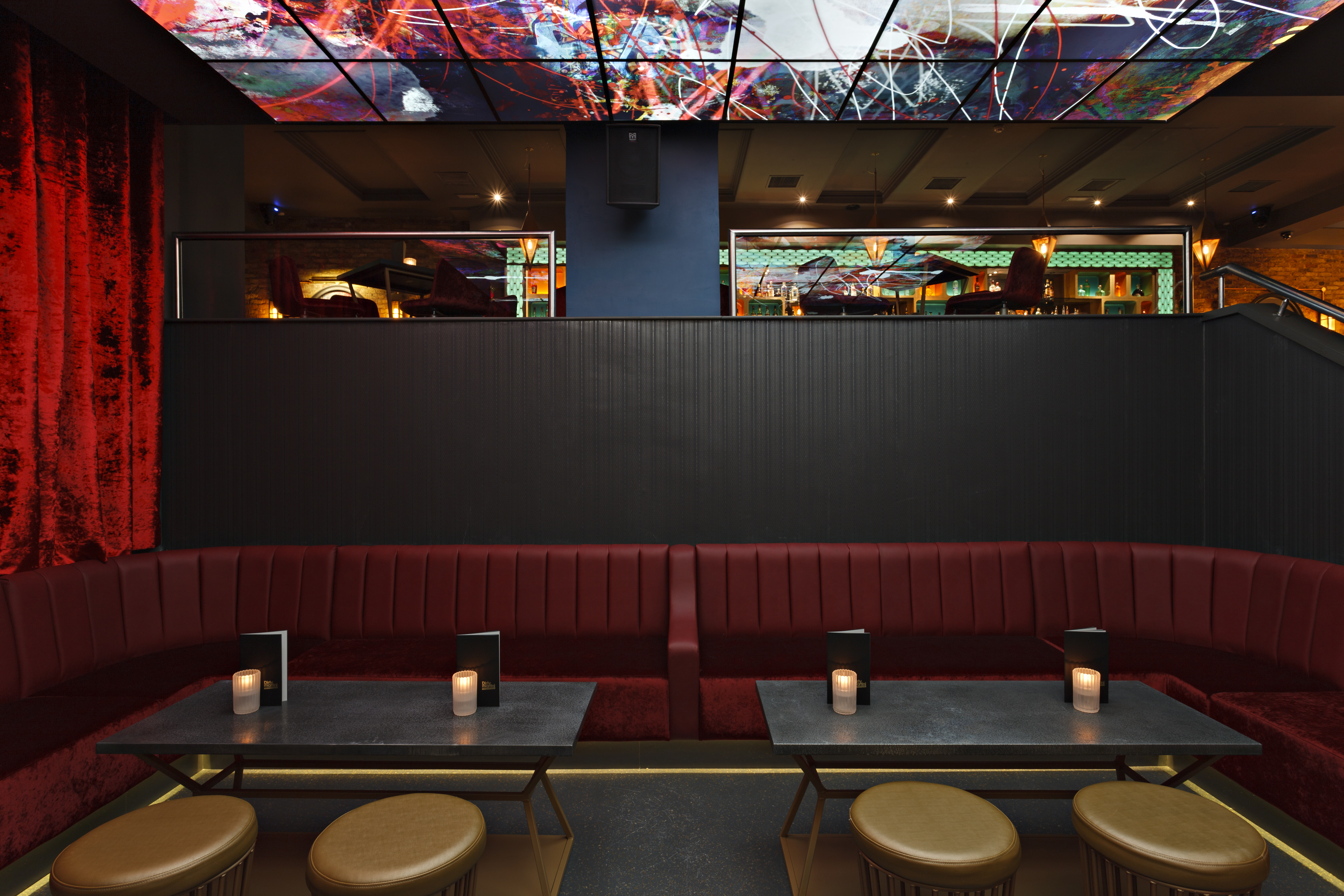Stylish Martini Den with plush red seating, ideal for creative events and social gatherings.