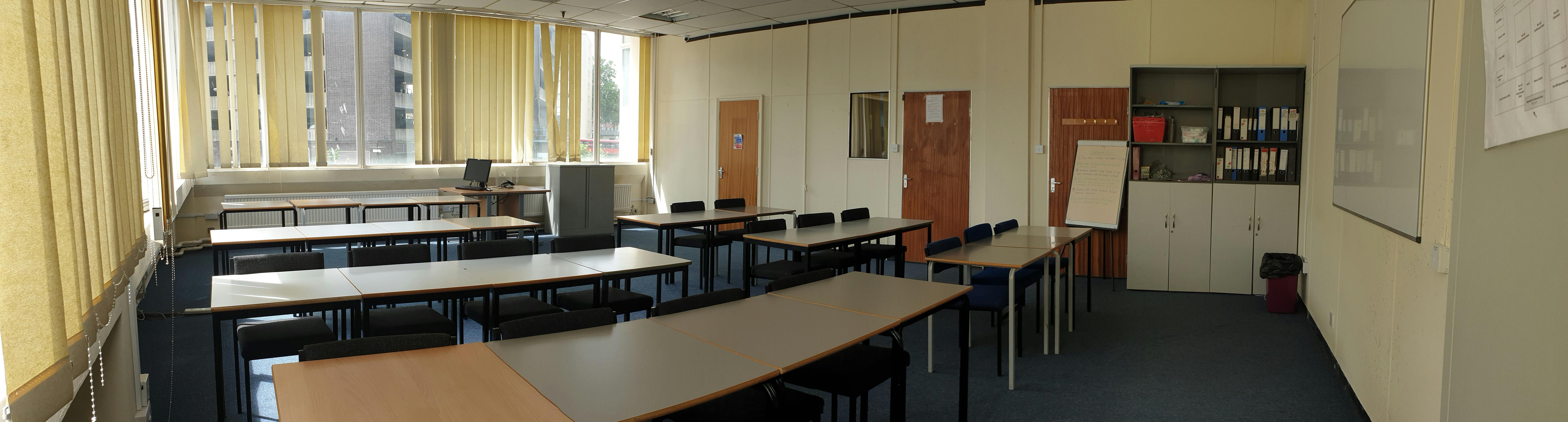 Versatile classroom at Woolwich College with natural light, ideal for workshops and training.