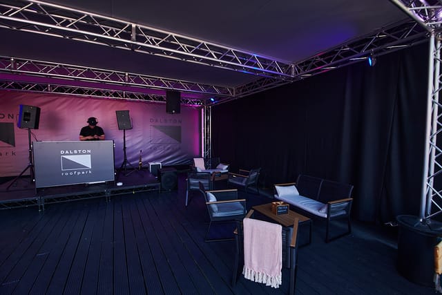 Dalston Roofpark rooftop event space with DJ booth, ideal for gatherings and networking.