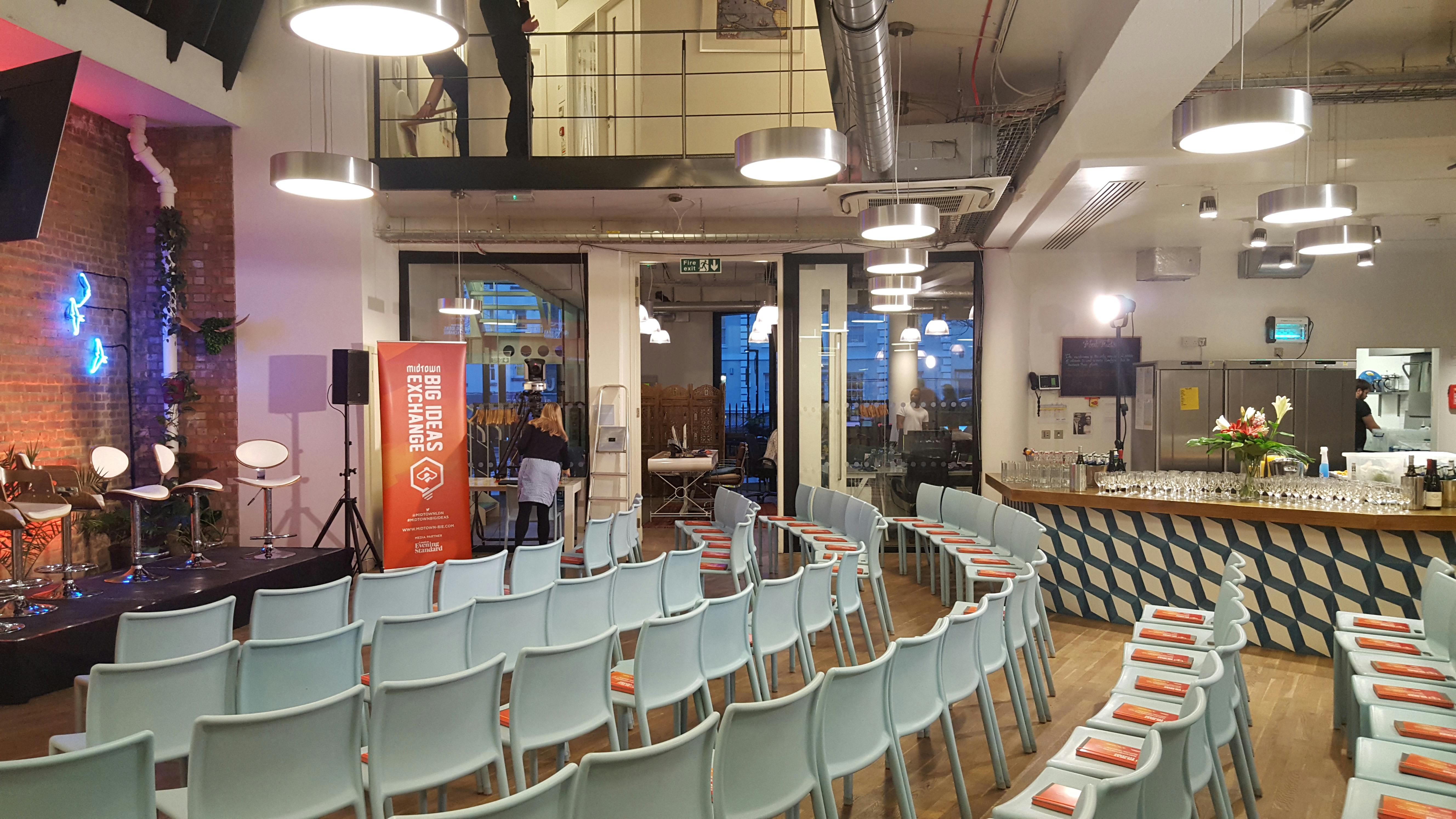 Modern event space at Clerkenwell Kitchen with light blue chairs for presentations.