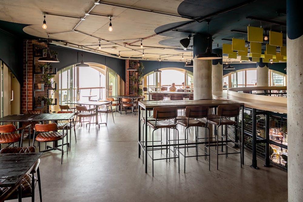 Modern Mezzanine venue with natural light, ideal for meetings and events.