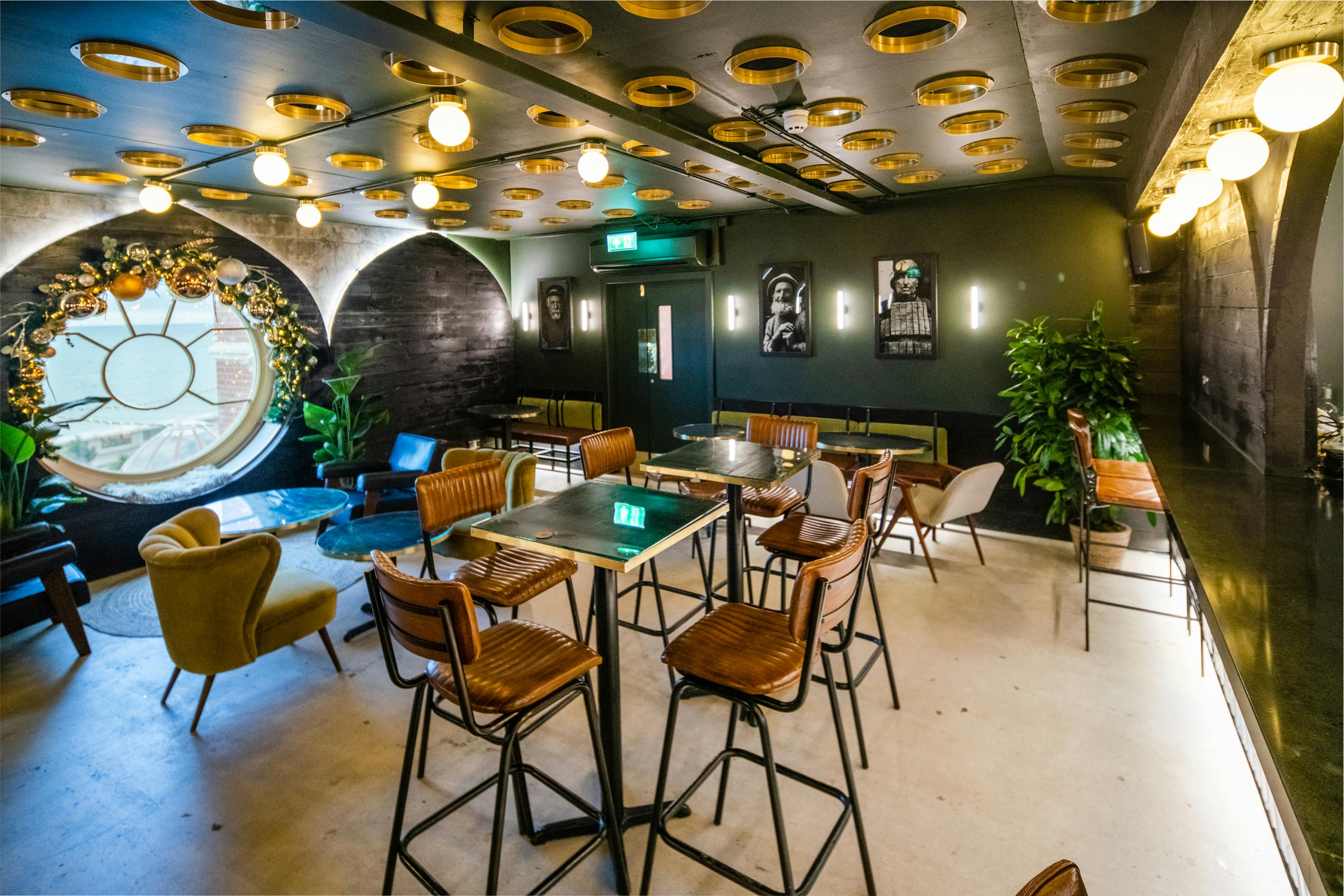Stylish event space with circular window, ideal for meetings and gatherings.