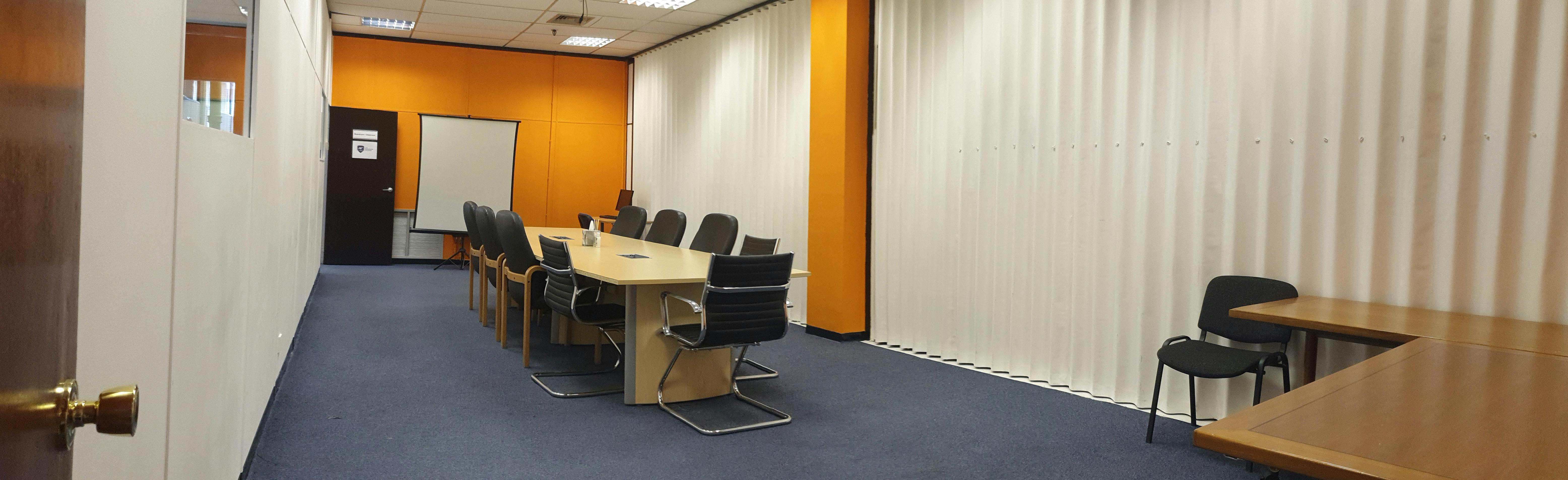 Boardroom at The Woolwich College with ergonomic chairs, ideal for meetings and presentations.