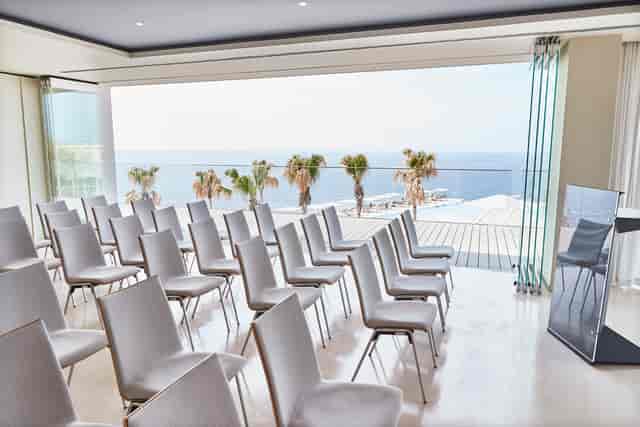 Es Vedra event space at 7Pines Resort Ibiza with ocean view and white chairs.