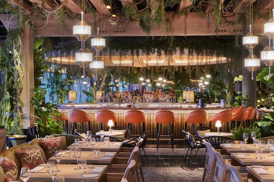 Vibrant restaurant setting with lush greenery for intimate gatherings and corporate events.