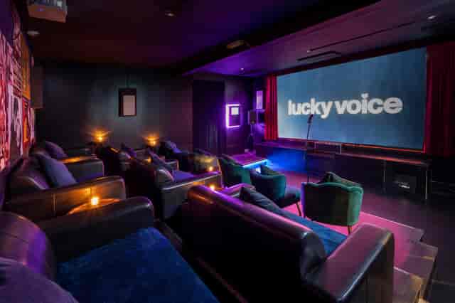 Stylish karaoke room with plush seating for corporate events and gatherings.