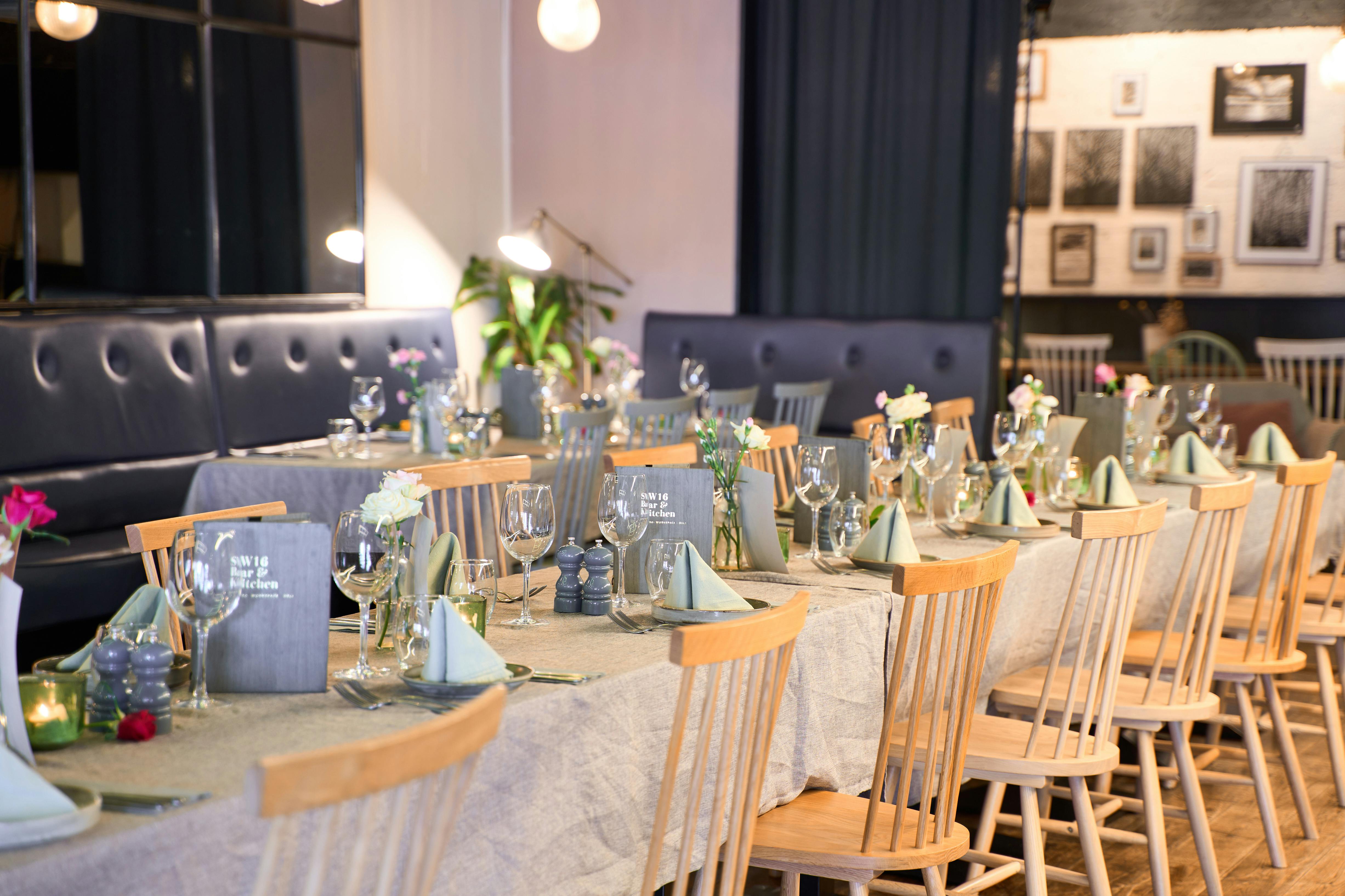 Elegant dining setup for intimate events at SW16 Bar and Kitchen, featuring floral centerpieces.