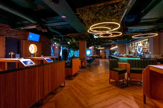 Modern event space with wooden furnishings for exclusive venue hire in Oche The Strand.