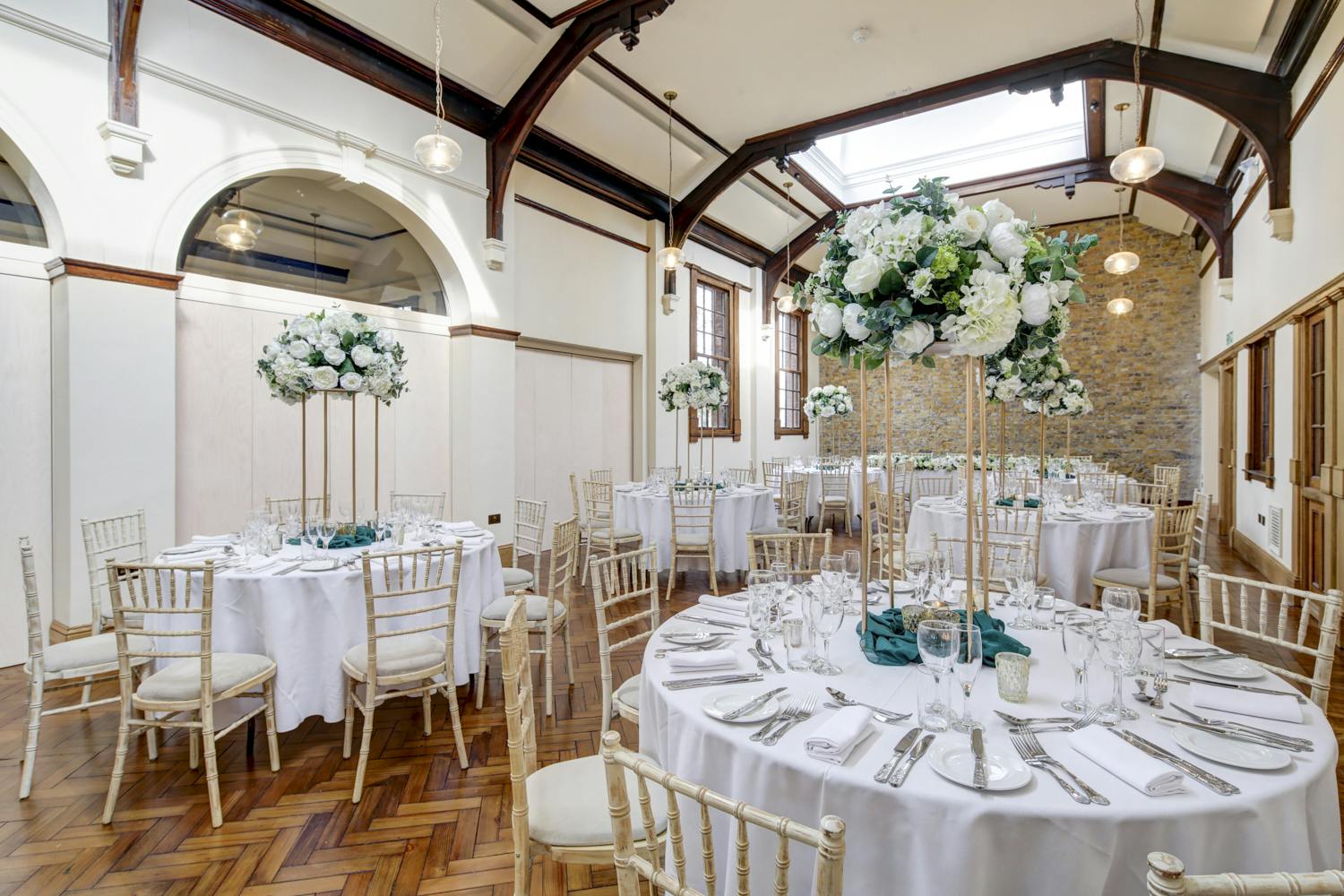 Elegant wedding venue with round tables and floral centerpieces in The Town Square.