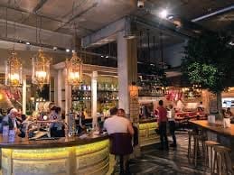 Tapas Revolution Bath: vibrant venue with warm lighting for networking events and gatherings.