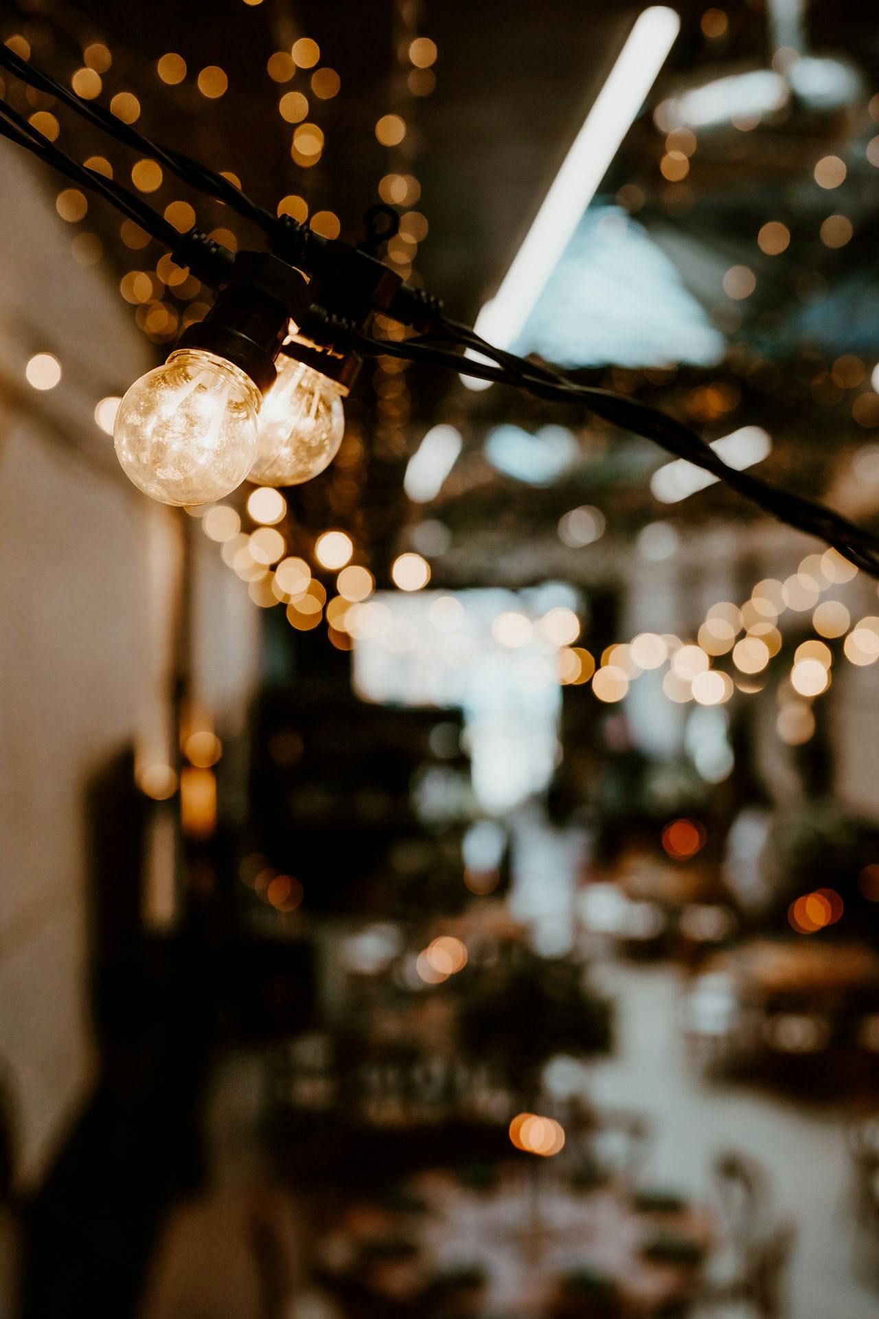 "Vennel event space with warm string lights, perfect for intimate gatherings and celebrations."