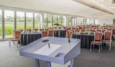Whimbrel Marquee event space with podium, ideal for corporate conferences and gatherings.